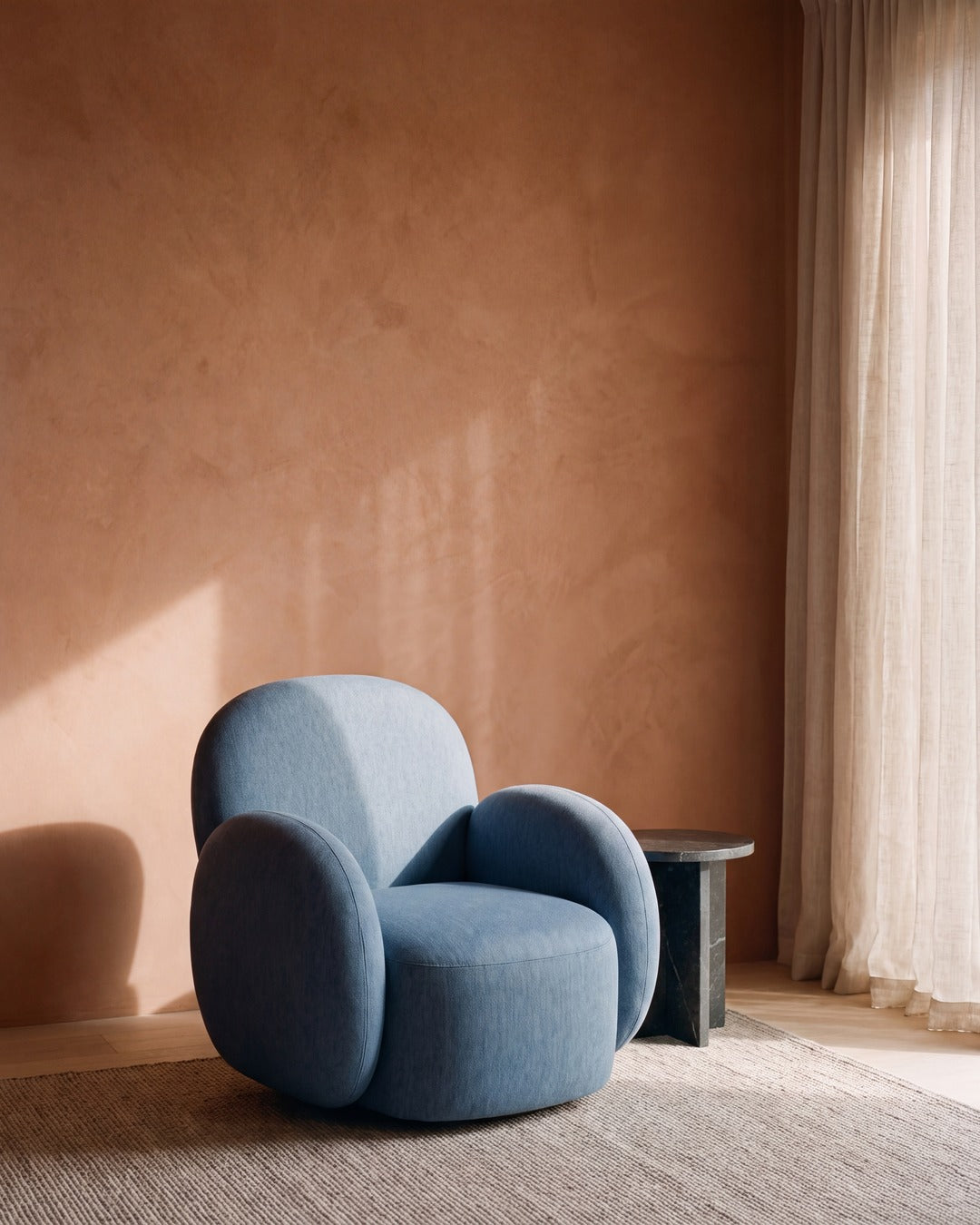 Talia swivel chair in Excite Baltic against a terracotta plaster wall