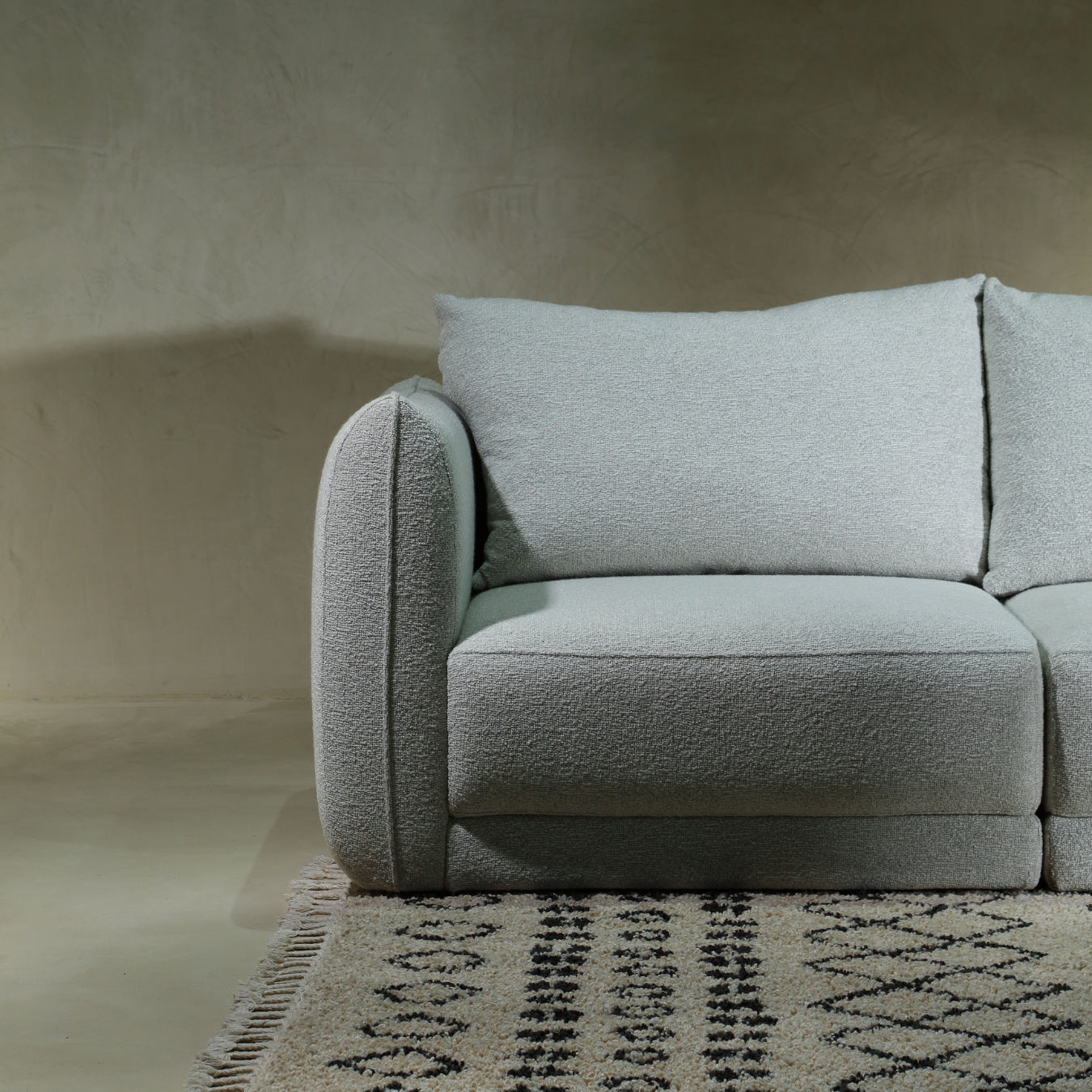 Muze light blue boucle modular sofa on patterned rug